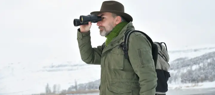 Man looking into binoculars